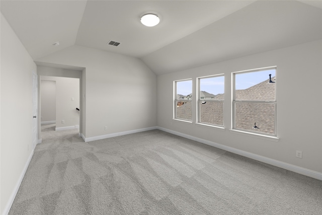 interior space with lofted ceiling and light colored carpet