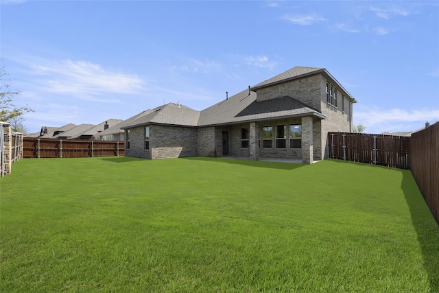 back of house with a lawn