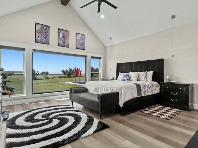 bedroom featuring high vaulted ceiling, light wood-type flooring, and ceiling fan