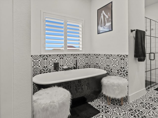 bathroom featuring plus walk in shower and tile patterned flooring