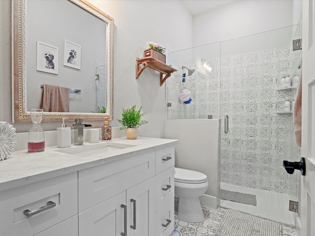 bathroom with vanity, toilet, a shower with door, and tile patterned floors