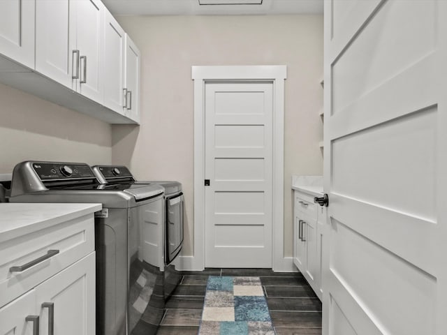 laundry room with cabinets, dark wood-type flooring, and washing machine and dryer