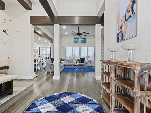 bedroom with wood-type flooring, beamed ceiling, and a fireplace