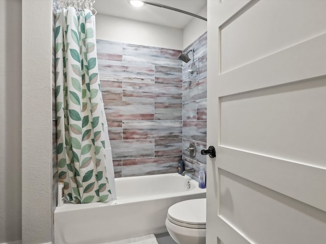 bathroom featuring shower / bathtub combination with curtain and toilet