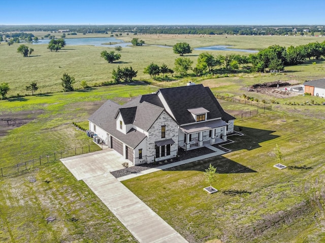 bird's eye view with a water view and a rural view