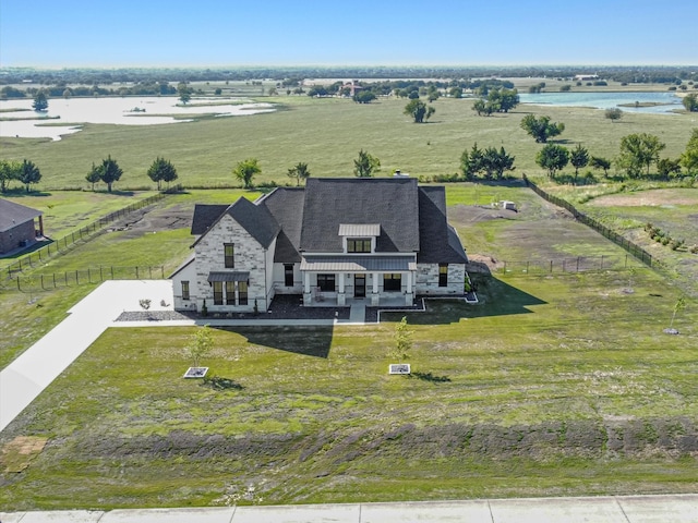 birds eye view of property featuring a water view and a rural view