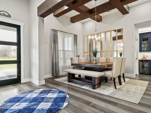 dining area with a notable chandelier, beverage cooler, dark hardwood / wood-style floors, and a wealth of natural light