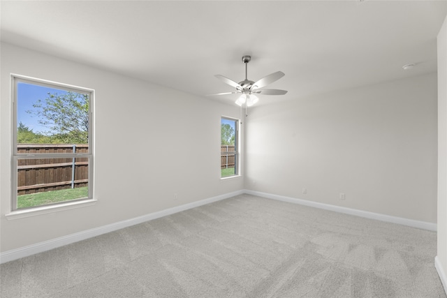 carpeted spare room with ceiling fan