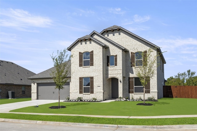 view of front of house with a front yard and a garage