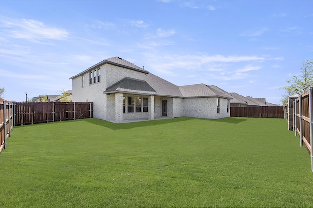 rear view of house featuring a yard