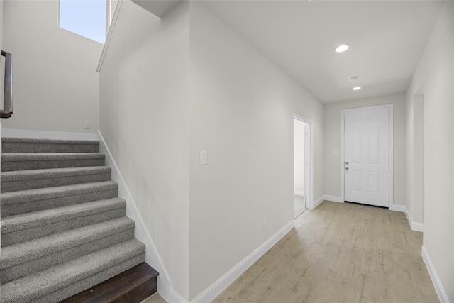 stairs with hardwood / wood-style floors