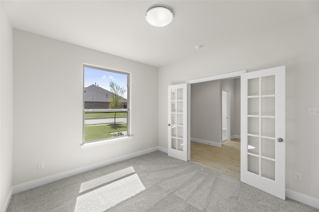 carpeted empty room with french doors