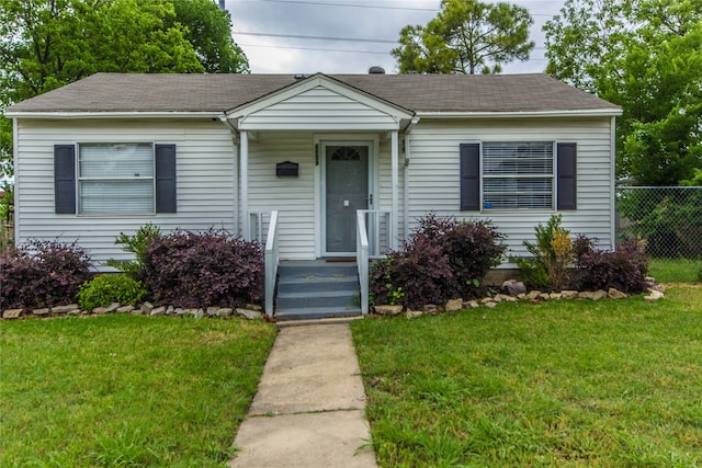 bungalow-style house featuring a front yard