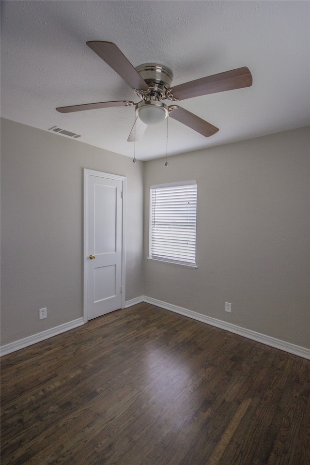 unfurnished room with a textured ceiling, ceiling fan, and dark hardwood / wood-style floors