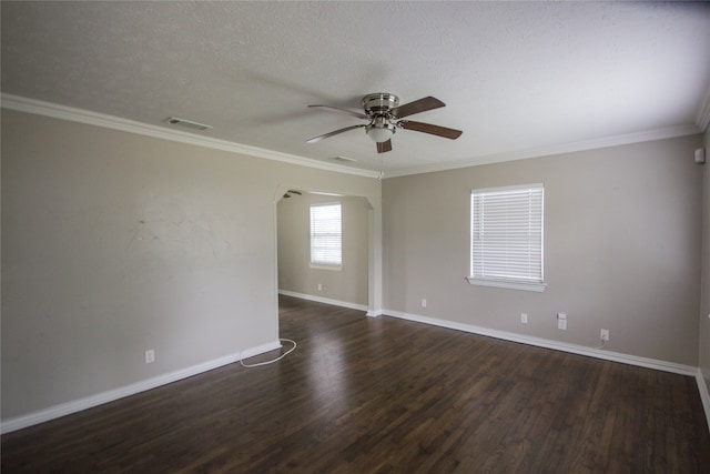 empty room featuring ceiling fan, dark hardwood / wood-style flooring, a textured ceiling, and ornamental molding