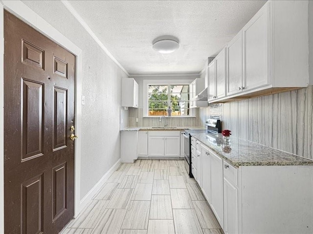 kitchen featuring sink, white cabinetry, electric range, light stone counters, and a textured ceiling