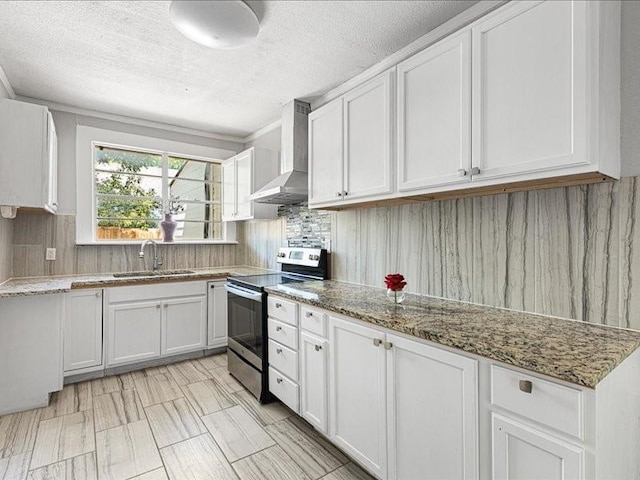 kitchen with wall chimney exhaust hood, sink, light stone counters, electric stove, and white cabinets