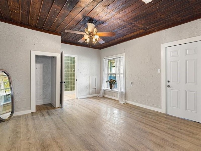 foyer entrance featuring ceiling fan, light wood-type flooring, and wooden ceiling