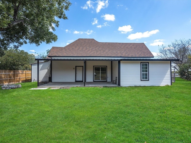 back of property with a patio area and a lawn