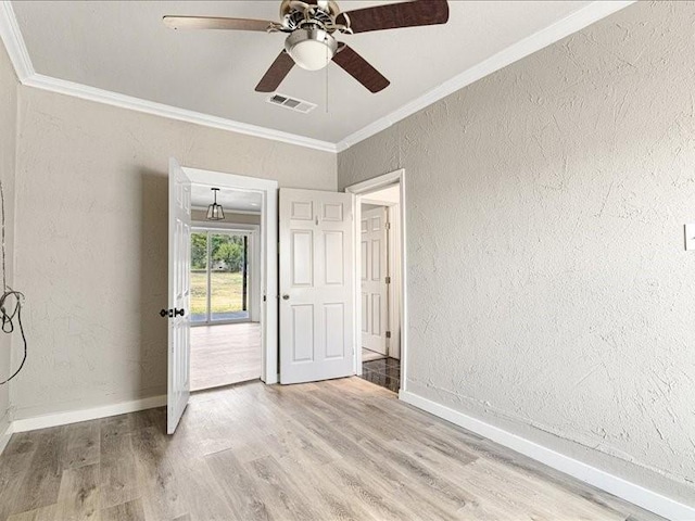 spare room with crown molding, ceiling fan, and hardwood / wood-style flooring