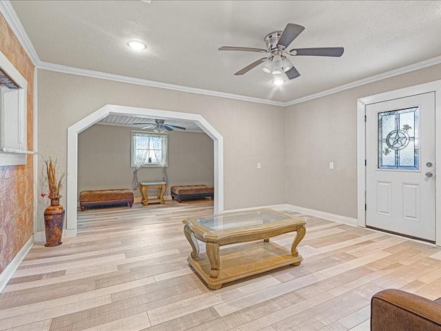 interior space with crown molding, light hardwood / wood-style flooring, and a textured ceiling