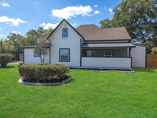 rear view of house featuring a yard