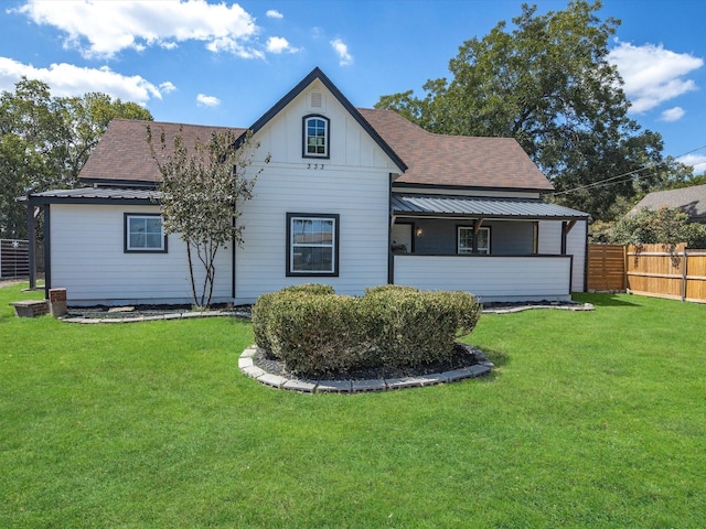 rear view of property featuring a lawn