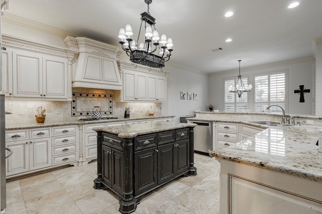 kitchen featuring a chandelier, pendant lighting, sink, ornamental molding, and appliances with stainless steel finishes