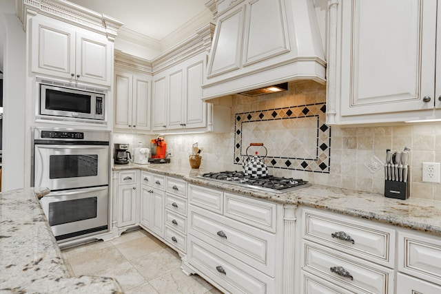 kitchen featuring premium range hood, stainless steel appliances, ornamental molding, and decorative backsplash