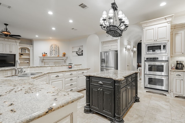 kitchen featuring light stone countertops, ornamental molding, stainless steel appliances, and sink