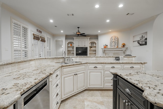 kitchen featuring ceiling fan, light stone countertops, and sink