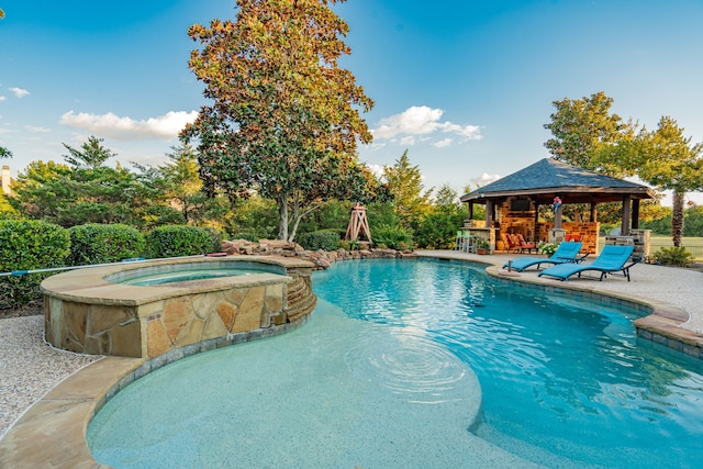 view of swimming pool featuring a gazebo and an in ground hot tub