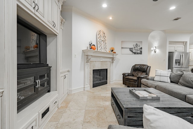 living room with a fireplace and ornamental molding