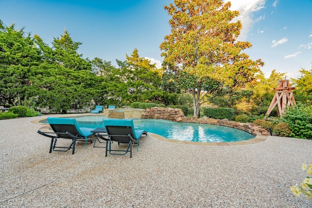 view of swimming pool featuring a patio