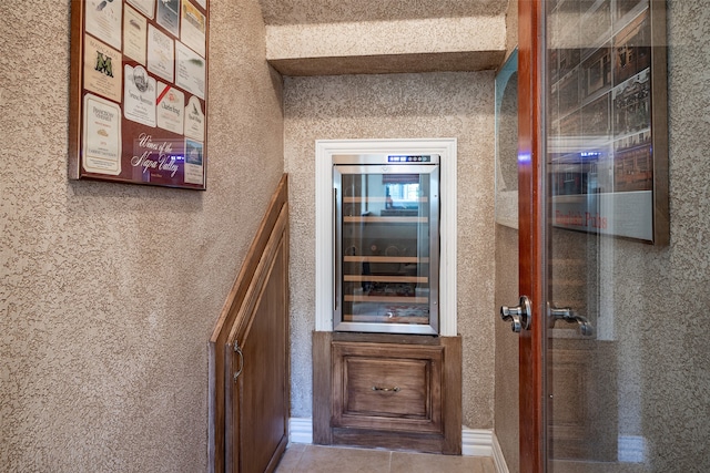 corridor featuring beverage cooler and tile patterned floors