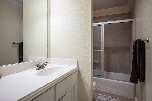 full bathroom with vanity, crown molding, toilet, and combined bath / shower with glass door