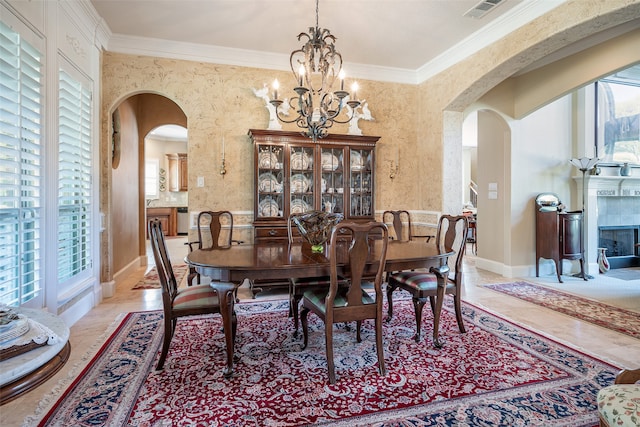 dining room featuring a notable chandelier, crown molding, and a wealth of natural light