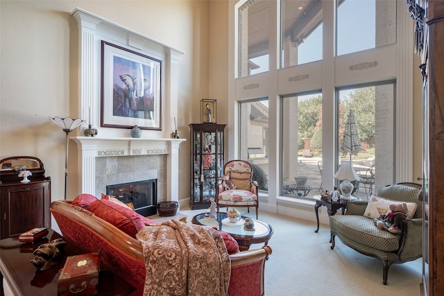 living room featuring a tiled fireplace and light colored carpet