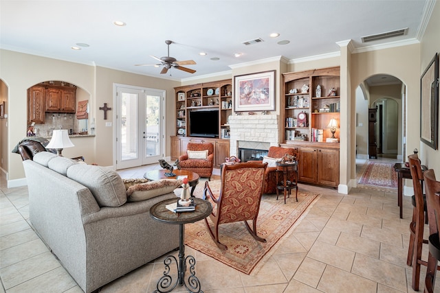 tiled living room featuring ceiling fan, french doors, and ornamental molding