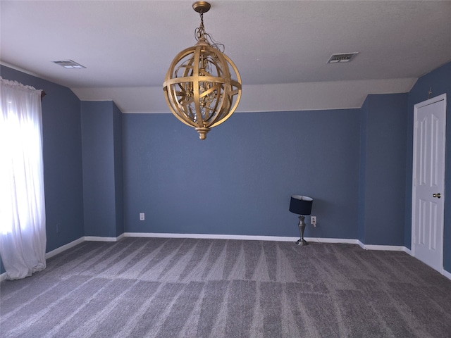 carpeted spare room with vaulted ceiling