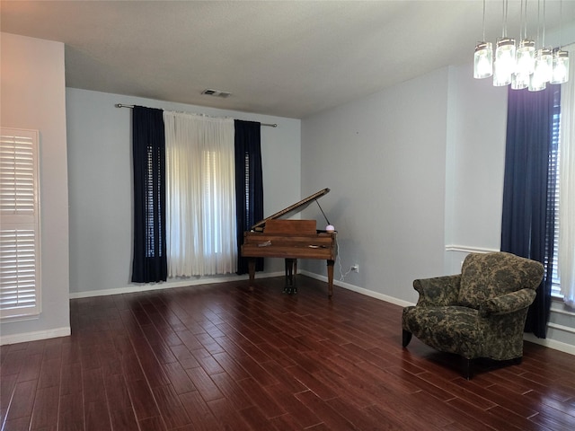 living area with dark hardwood / wood-style floors and a chandelier