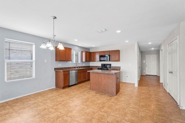 kitchen featuring pendant lighting, sink, black appliances, a center island, and a notable chandelier