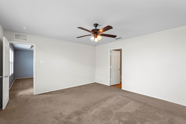 carpeted spare room with ceiling fan