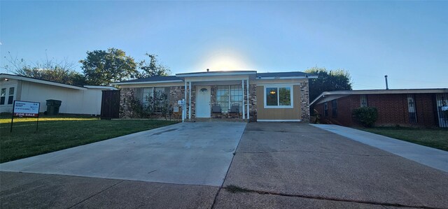 ranch-style home with a front lawn