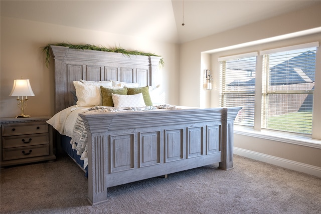 bedroom featuring lofted ceiling and carpet flooring