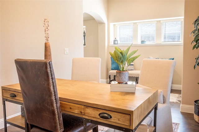 dining area featuring dark wood-type flooring