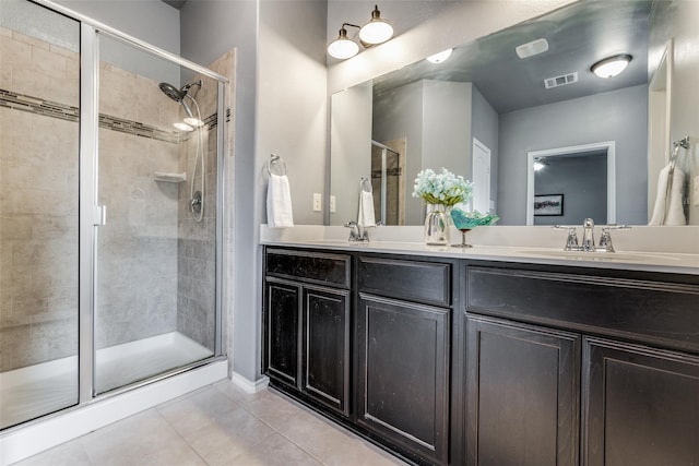 bathroom with vanity, a shower with shower door, and tile patterned floors