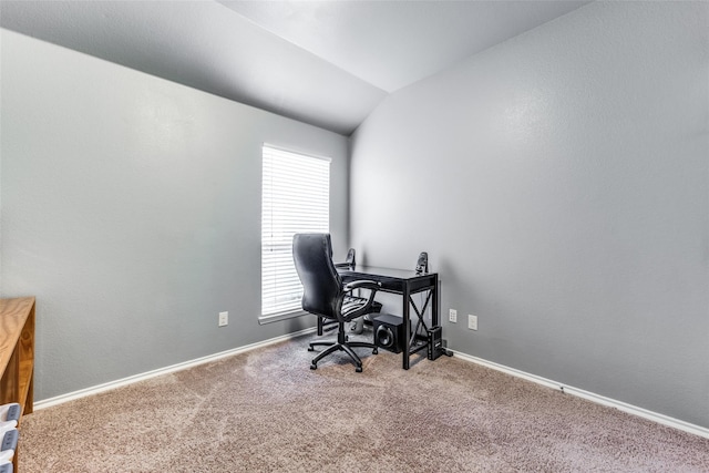 carpeted office space with a healthy amount of sunlight and vaulted ceiling