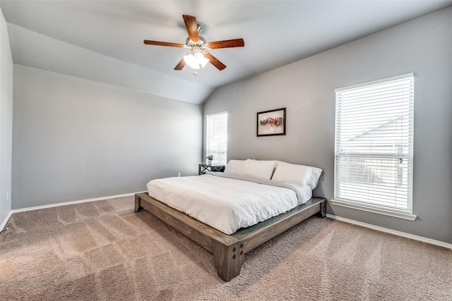 bedroom featuring lofted ceiling, carpet flooring, ceiling fan, and multiple windows