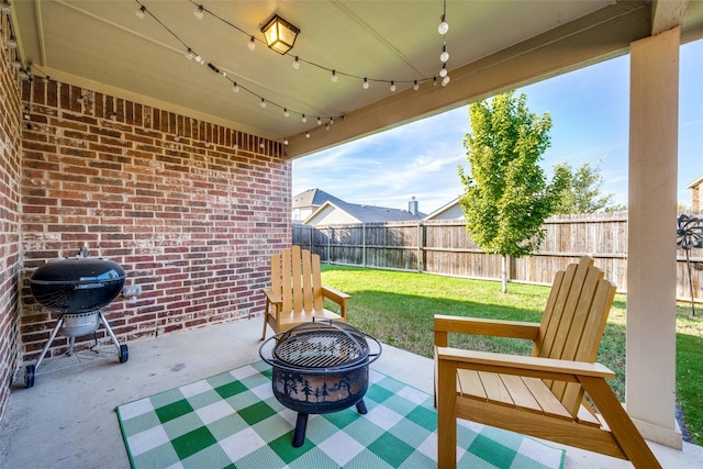 view of patio / terrace featuring a grill and an outdoor fire pit